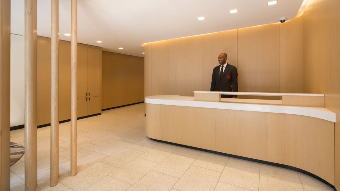 View of a building lobby with a concierge desk.