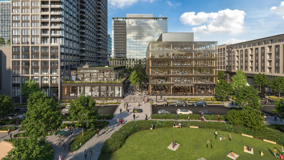 Image of a park in a city. Buildings in the background are labeled "Pinstripes" and "Green Craft Brewing." 